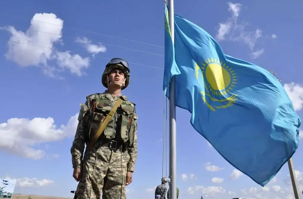 Военный у флага Казахстана